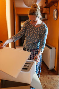 Woman holding umbrella at home