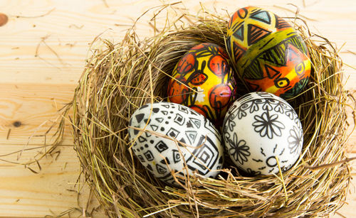 High angle view of colorful easter eggs in nest on table