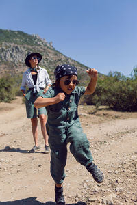 Child boy walks with his mother in the mountains in the summer