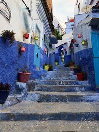 Low angle view of steps amidst buildings in town