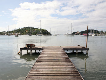 View of pier in river against sky