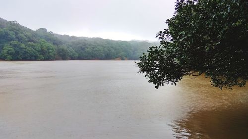 Scenic view of river against sky during rainy season