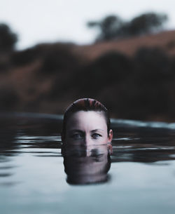 Portrait of young man swimming in pool