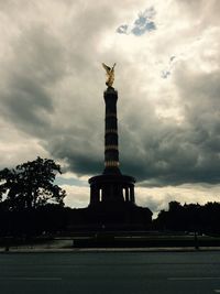 Low angle view of statue against cloudy sky