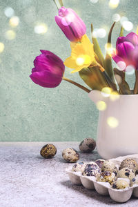 Close-up of pink roses in vase on table