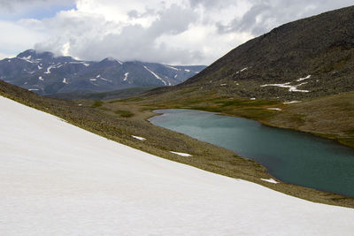 Alpine mountain lake landscape and view, snow and clouds in javakheti, georgia