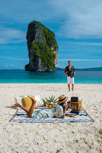 Couple enjoying picnic on beach