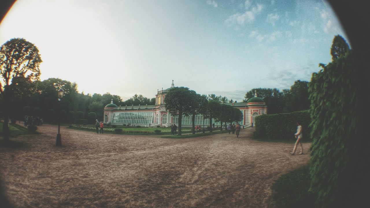 built structure, architecture, tree, sky, building exterior, sunlight, incidental people, travel, travel destinations, day, outdoors, history, place of worship, religion, famous place, nature, tourism, lens flare, sunbeam, no people