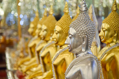 Close-up of buddha statues in temple