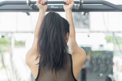 Rear view of woman exercising in gym