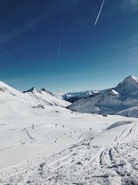 Snow covered mountain against blue sky