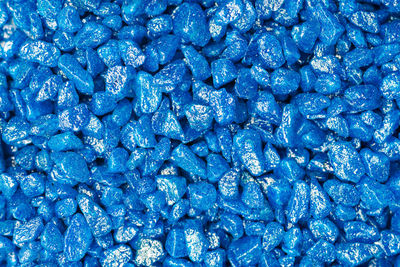 Light blue gemstone fake pattern. blue glitter stones for garden decoration, flat lay background