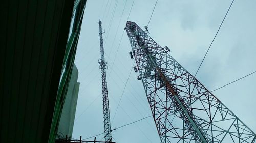 Low angle view of electricity pylon against sky