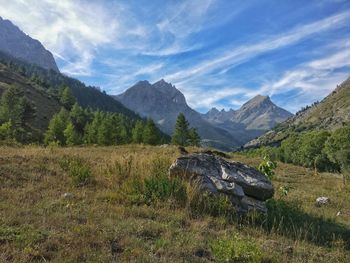 Scenic view of land and mountains against sky