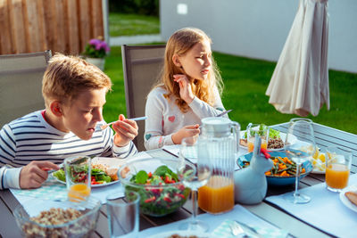 High angle view of people sitting on table