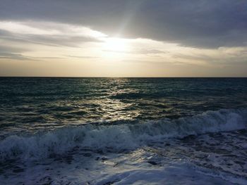 Scenic view of sea against cloudy sky