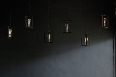 Illuminated electric lamp hanging on wall