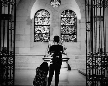 Full length of woman standing by railing
