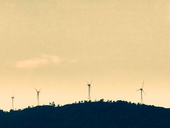 Silhouette of windmill against sky during sunset