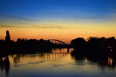 Scenic view of river against sky during sunset