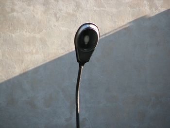 Low angle view of electric lamp on wall