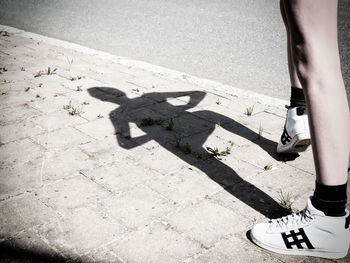 Low section of man standing on ground