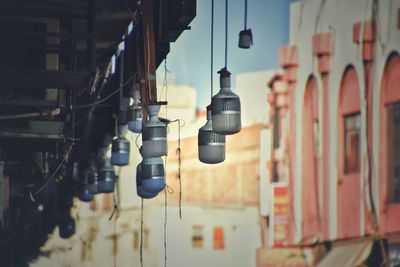 Close-up of light bulb hanging on building