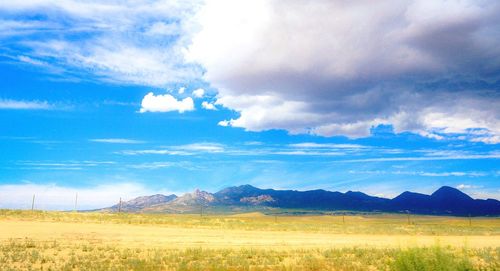 Scenic view of mountains against cloudy sky