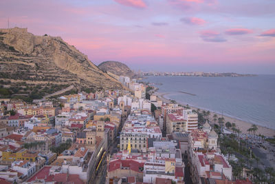 Aerial view of alicante city and beach at sunset, spain.