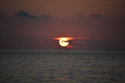 Scenic view of sea against romantic sky at sunset