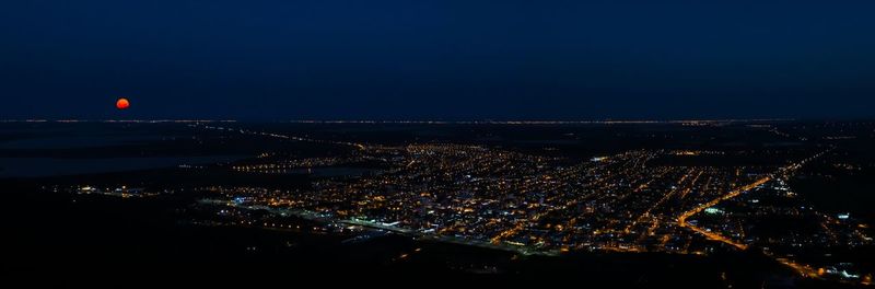 High angle view of city lit up at night