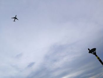 Low angle view of airplane flying in sky