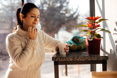 Woman with coffee cup on table