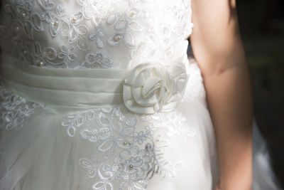 Midsection of woman standing against white background