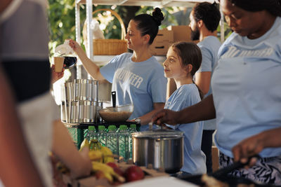 Rear view of people working at table