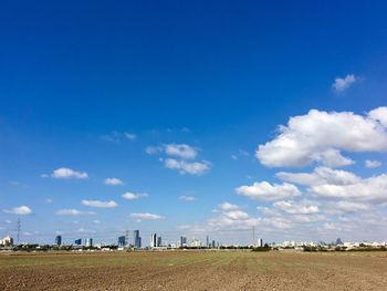 Scenic view of field with city in the distance