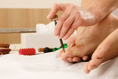 Cropped hand of person holding thermometer