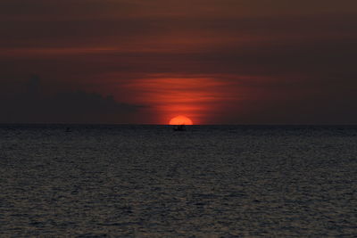 Scenic view of sea against orange sky