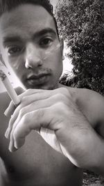 Close-up portrait of young man holding hands