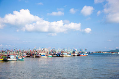 Boats moored in sea against sky