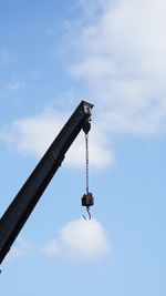 Low angle view of crane against sky