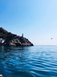 Scenic view of sea against clear blue sky