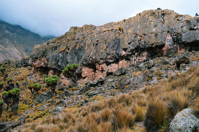 Volcanic rock formations against a foggy mountain landscape, mount kenya, mount kenya national park