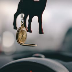 Close-up of pocket watch hanging in car