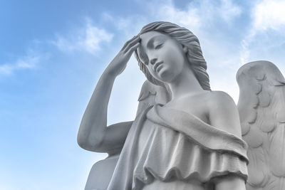 Low angle view of statue against sky