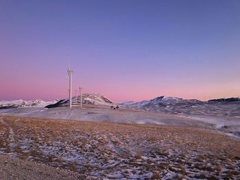 Scenic view of snowcapped mountains against clear sky during sunset