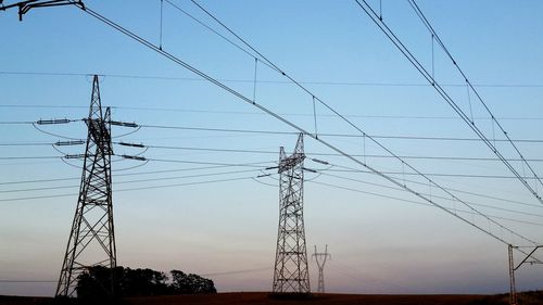 Low angle view of electricity pylon against sky