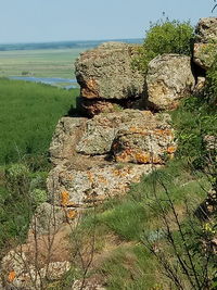 Stone wall by sea against sky