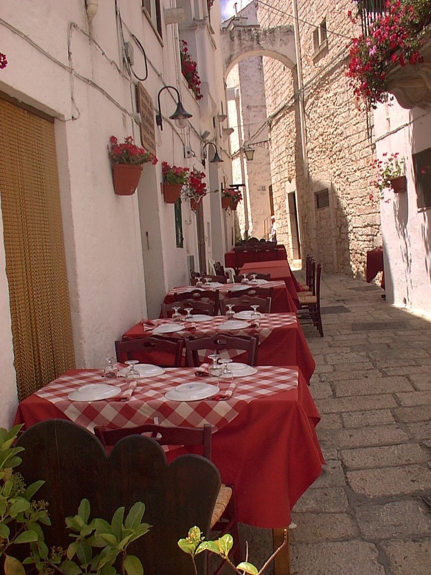 RED TABLE AND CHAIRS HANGING ON TABLES