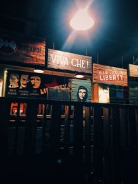 Low angle view of illuminated sign at restaurant